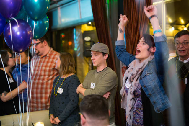 Group of attendees celebrating at the Love Bomb 2017 event, with colorful balloons and expressions of joy, highlighting community engagement for My Voice Music nonprofit.